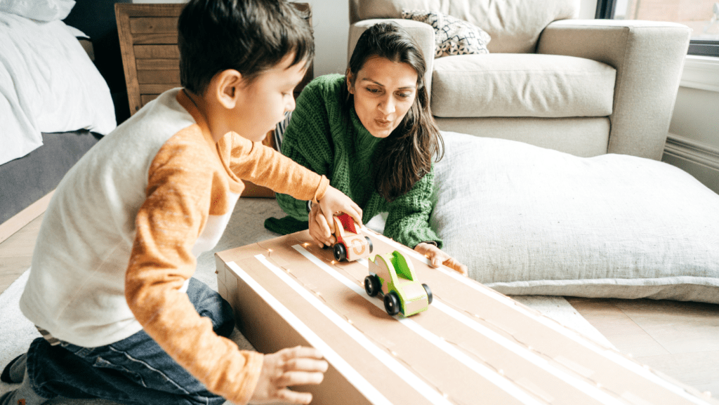 mother and son playing with toy cars
